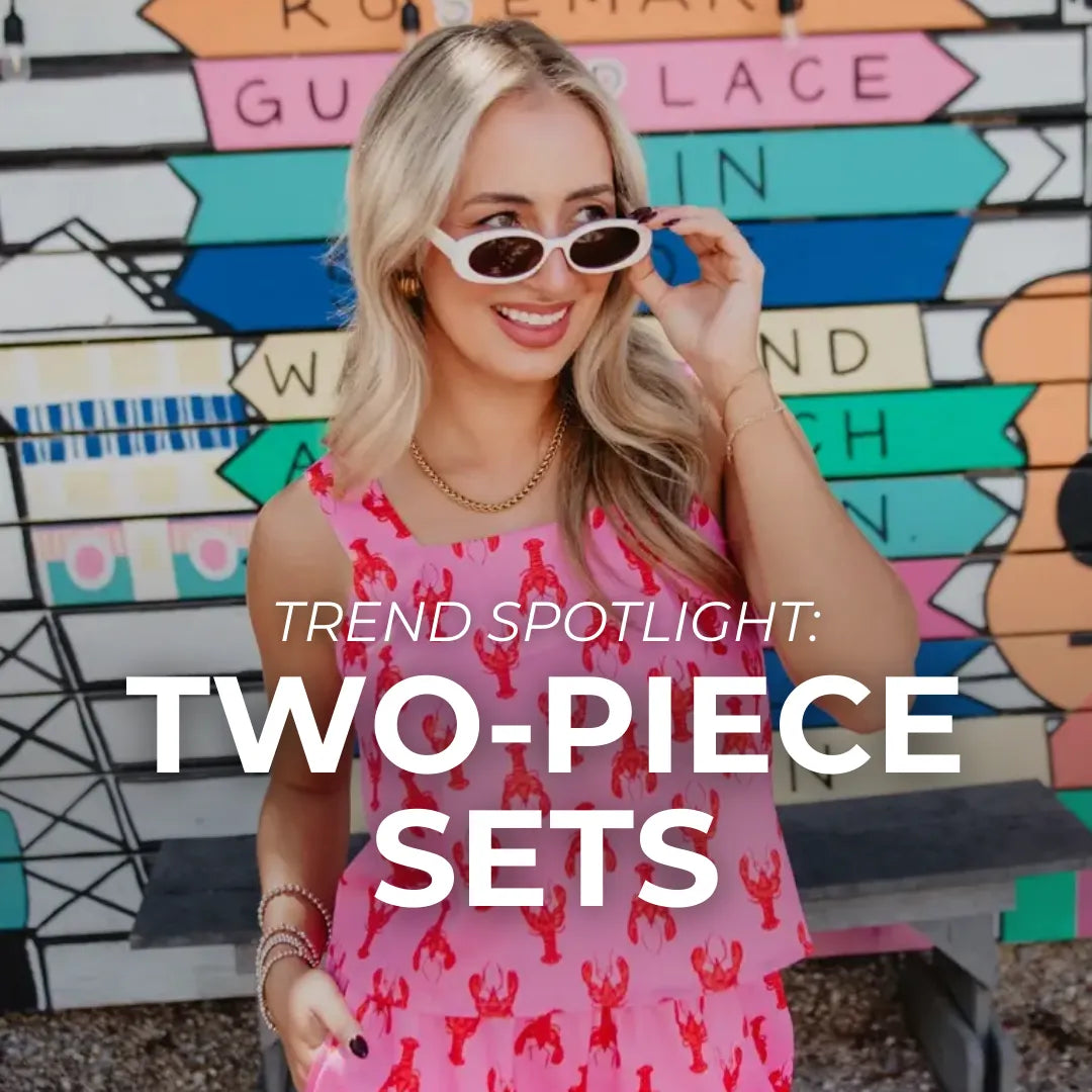 A woman wearing a pink lobster printed two-piece set