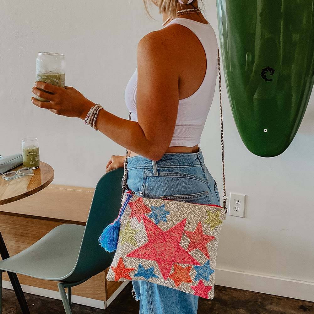 woman in a store wearing a colorful star purse
