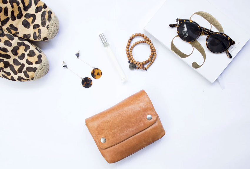 women’s fashion accessories scattered on a white backdrop
