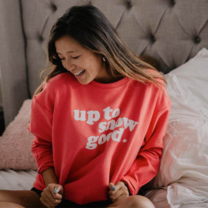 woman sitting on a bed wearing an up to snow good corded sweatshirt
