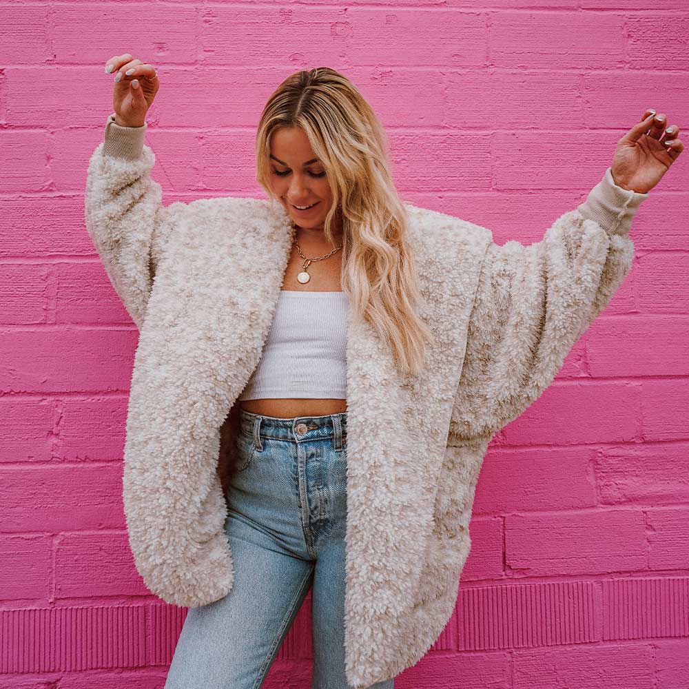 woman wearing a snow leopard wrap and mom jeans