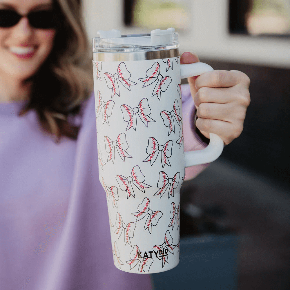Woman holding a bow print beach tumbler