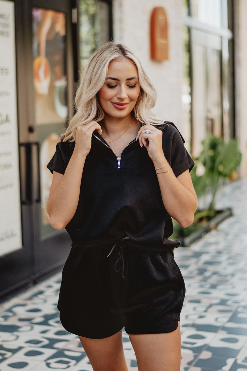 A woman wearing a black scuba set and shorts