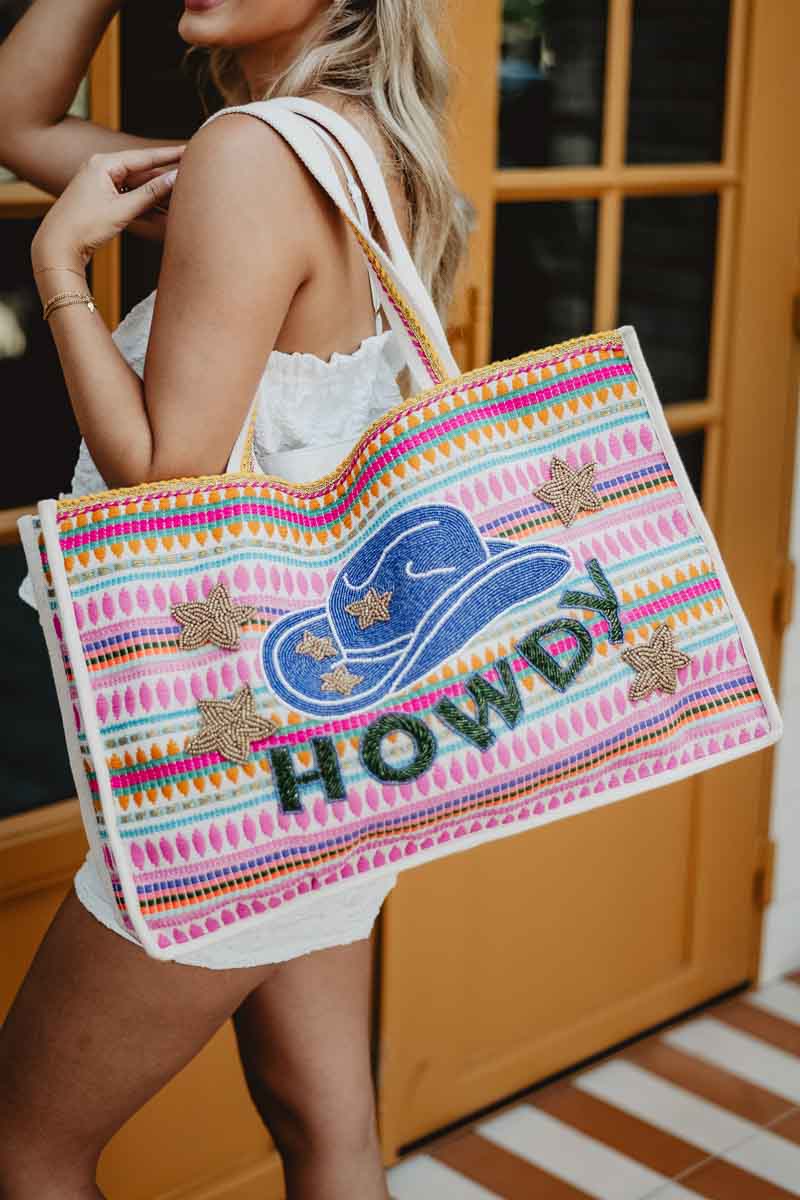 woman carrying a howdy western oversized tote bag
